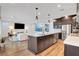 Open concept kitchen with large island, stainless appliances, and seamless flow to the living area at 4177 Railhead Pass Ave, Las Vegas, NV 89141