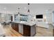 Open kitchen with island bar, flows into the dining area and living space for seamless entertaining at 4177 Railhead Pass Ave, Las Vegas, NV 89141