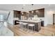 Kitchen with stainless steel appliances, dark cabinetry, and center island with barstool seating at 4177 Railhead Pass Ave, Las Vegas, NV 89141