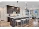 Modern kitchen with stainless steel appliances, dark wood cabinets, and granite countertops at 4177 Railhead Pass Ave, Las Vegas, NV 89141