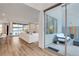 Open floor plan with living room, patio, and wood floors, creating seamless indoor/outdoor flow at 4177 Railhead Pass Ave, Las Vegas, NV 89141