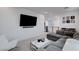 Upstairs living area with sectional, sleek TV, and modern decor, offering a cozy space at 4177 Railhead Pass Ave, Las Vegas, NV 89141