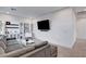 Open-concept living room with a gray sectional, white coffee table, and built-in shelving at 4177 Railhead Pass Ave, Las Vegas, NV 89141