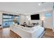 Bright and airy living room featuring a plush sectional sofa, stylish decor, and sliding glass doors at 4177 Railhead Pass Ave, Las Vegas, NV 89141