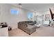 A sunlit living room features a gray sectional sofa, a white coffee table and a modern bookshelf at 4177 Railhead Pass Ave, Las Vegas, NV 89141