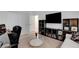 Comfortable living room showcasing a large TV, bookshelves, modern decor, and a glass coffee table at 4177 Railhead Pass Ave, Las Vegas, NV 89141