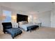 Spacious main bedroom featuring a large window, a dark bed frame, and stylish furnishings at 4177 Railhead Pass Ave, Las Vegas, NV 89141