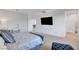 Spacious main bedroom featuring a large bed, a large TV, a window, and an attached bathroom at 4177 Railhead Pass Ave, Las Vegas, NV 89141