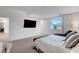 View of a main bedroom featuring a large TV, a view out the window, and access to an attached bathroom at 4177 Railhead Pass Ave, Las Vegas, NV 89141