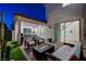 Relaxing covered patio area featuring a fire pit, dining set, and comfortable seating arrangement at 4177 Railhead Pass Ave, Las Vegas, NV 89141