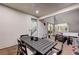 Spacious covered patio features a dining area, grill, and comfortable seating with a view into the home at 4177 Railhead Pass Ave, Las Vegas, NV 89141