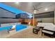 Stunning backyard oasis featuring a sparkling pool, cozy fire pits, and comfortable seating for ultimate relaxation at 4177 Railhead Pass Ave, Las Vegas, NV 89141