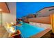 Gorgeous backyard pool with water features, lush greenery, and cozy seating, perfect for outdoor enjoyment at 4177 Railhead Pass Ave, Las Vegas, NV 89141