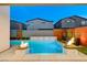 Beautiful backyard pool with sleek marble accents, decorative water features, and vibrant landscaping at 4177 Railhead Pass Ave, Las Vegas, NV 89141