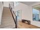 Carpeted staircase with modern metal railings, leading to bright, open floor plan with patio view at 4177 Railhead Pass Ave, Las Vegas, NV 89141