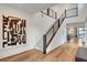 Modern staircase with metal railings, leading to the second floor, with an art piece adorning the wall at 4177 Railhead Pass Ave, Las Vegas, NV 89141