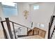 Staircase leading to entryway with wood floors and modern chandelier, offering a bright and inviting space at 4177 Railhead Pass Ave, Las Vegas, NV 89141