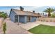 Private backyard featuring desert landscaping, artificial turf, and a concrete patio at 4205 Caliper Dr, Las Vegas, NV 89110