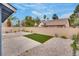 Private backyard featuring desert landscaping, artificial turf, and a concrete patio at 4205 Caliper Dr, Las Vegas, NV 89110