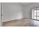 Bright bedroom features wood-look tile floors, neutral paint, and a sliding glass door at 4205 Caliper Dr, Las Vegas, NV 89110