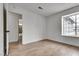 An empty bedroom with an open bathroom, featuring modern flooring and a large window at 4205 Caliper Dr, Las Vegas, NV 89110
