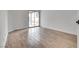 Bright bedroom featuring wood-look tile floors, neutral paint, and a sliding glass door at 4205 Caliper Dr, Las Vegas, NV 89110