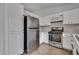 Well-lit kitchen with stainless steel refrigerator, oven, and ample cabinet space at 4205 Caliper Dr, Las Vegas, NV 89110