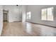 Bright living room with wood-look tile floors, vaulted ceilings, and natural light at 4205 Caliper Dr, Las Vegas, NV 89110
