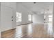 Bright living room with wood-look tile floors, vaulted ceilings, and natural light at 4205 Caliper Dr, Las Vegas, NV 89110