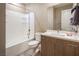 Well-lit bathroom featuring a tub/shower combo, toilet, and a wood-look vanity at 4289 Sunrise Flats St, Las Vegas, NV 89135