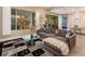 Cozy living room with a plush sofa, glass-top coffee table, and views of the backyard at 4289 Sunrise Flats St, Las Vegas, NV 89135