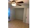 Empty bedroom featuring a ceiling fan, tiled floors, closet and adjoining door at 4626 Sacks Dr, Las Vegas, NV 89122