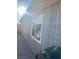 The exterior side of the house with a window and gravel, showcasing the structure and natural light at 4626 Sacks Dr, Las Vegas, NV 89122
