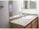 Granite countertop and sink with a large mirror over a wooden vanity at 5055 W Hacienda Ave # 2125, Las Vegas, NV 89118
