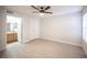 Spacious bedroom with modern ceiling fan, wood-look floors and attached bathroom at 5055 W Hacienda Ave # 2125, Las Vegas, NV 89118