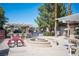 Common area with picnic table, fire pit and bar stools under a pergola at 5055 W Hacienda Ave # 2125, Las Vegas, NV 89118
