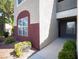 Condominium exterior showing a red accented wall and neat landscaping at 5055 W Hacienda Ave # 2125, Las Vegas, NV 89118