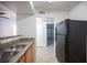 Kitchen view featuring stainless steel sink, granite counters, and a black refrigerator at 5055 W Hacienda Ave # 2125, Las Vegas, NV 89118