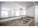 Kitchen sink and countertop area with pass-through to living room, and ample lighting at 5055 W Hacienda Ave # 2125, Las Vegas, NV 89118