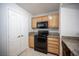 Bright kitchen featuring wood cabinets, granite countertops, and black appliances at 5055 W Hacienda Ave # 2125, Las Vegas, NV 89118