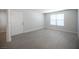 Empty living room featuring a large window for natural light and modern wood-look flooring at 5055 W Hacienda Ave # 2125, Las Vegas, NV 89118