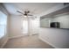 Open-concept living area with wood-look floors, a ceiling fan, and a kitchen view at 5055 W Hacienda Ave # 2125, Las Vegas, NV 89118