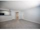 Open living room with wood-look floors, white walls, and views to other rooms at 5055 W Hacienda Ave # 2125, Las Vegas, NV 89118