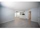 Open-concept living room featuring gray wood-look floors, view of the kitchen, and white cabinets at 5055 W Hacienda Ave # 2125, Las Vegas, NV 89118