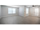 Bright living room featuring wood-look flooring, two windows, a ceiling fan, and a glass door at 5055 W Hacienda Ave # 2125, Las Vegas, NV 89118