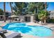 Community pool with lounge chairs, shaded tables and a cabana at 5055 W Hacienda Ave # 2125, Las Vegas, NV 89118