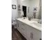 Bathroom featuring a double sink vanity, modern fixtures, and a decorative mirror at 600 N Carriage Hill Dr # 1082, Las Vegas, NV 89138