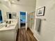 Bright bathroom featuring double sinks, modern shower, and attractive wood-look flooring at 600 N Carriage Hill Dr # 1082, Las Vegas, NV 89138