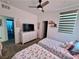 Bedroom featuring twin beds, neutral color scheme, natural light and a TV on a bureau at 600 N Carriage Hill Dr # 1082, Las Vegas, NV 89138