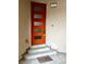 Eye-catching orange front door with stylish glass panels and a welcoming doormat at 600 N Carriage Hill Dr # 1082, Las Vegas, NV 89138